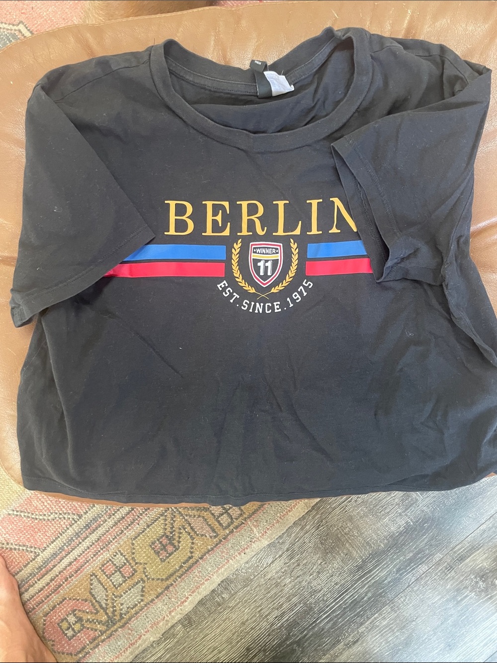 Divided Black Berlin Graphic Tee with Yellow, Blue & Red Accents